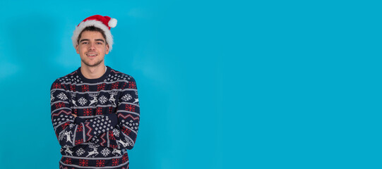 young man in santa claus hat isolated on color background