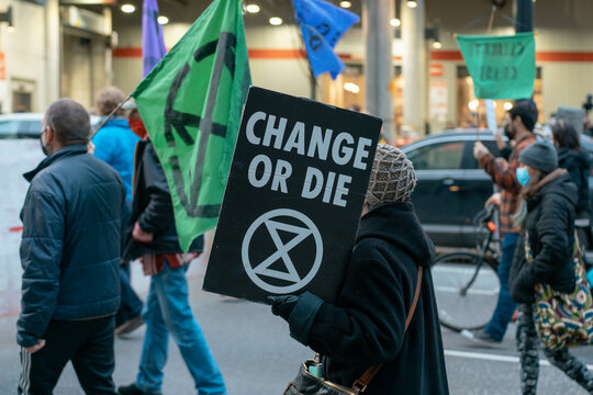 Vancouver Canada - November 21, 2021: A woman holds a sign while protestors block traffic during a Vancouver Canucks game near Downtown Vancouver