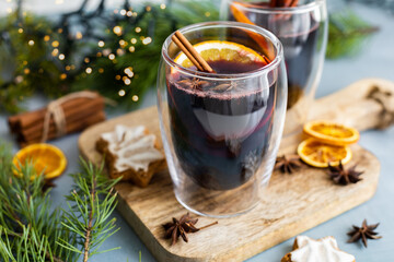 Hot freshly brewed homemade mulled wine with orange slices, cinnamon stick and anise. Traditional...