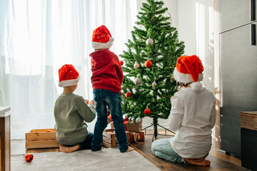 New Year and Merry Christmas. Children prepare for the holiday and decorate the Christmas tree with...