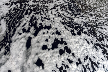 Active foam on top of the black car.