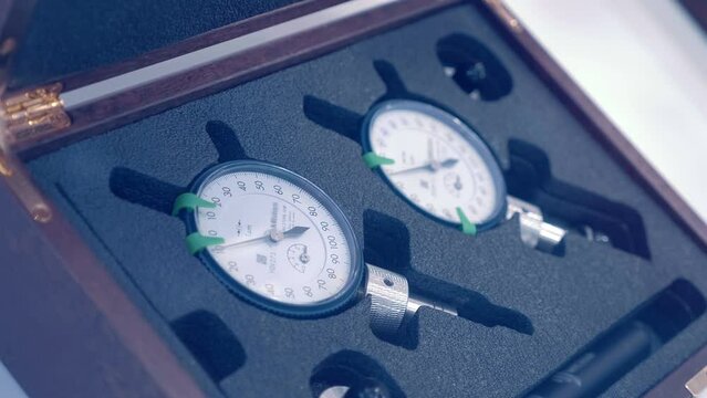 A set of two high-quality, accurate pointer micrometers and accessories for them. Closeup. Follow focus