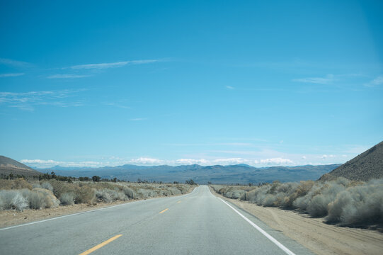 Driving down Highway 178 in the Mojave Desert of California with the Sierra Nevada Mountain Range in the Horizon