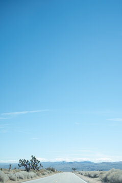 Driving down Highway 178 in the Mojave Desert of California with the Sierra Nevada Mountain Range in the Horizon