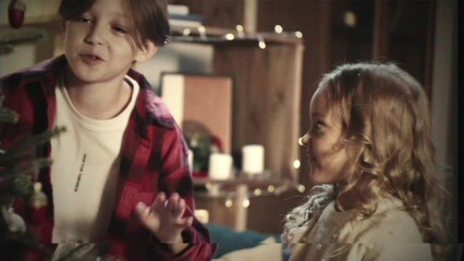 Retro Vhs Tape Effect, Home video, Kids decorating christmas tree in living room. Children hanging toys on branches close-up. New year routine, holidays. Winter atmosphere, tradition concept.