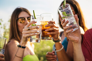 Cheerful millennial friends toasting in the summer - people lifestyle concept