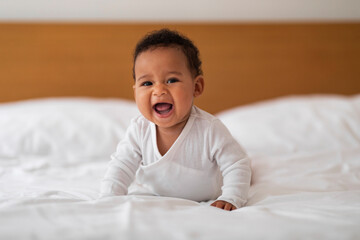 Adorable Small Black Baby Crawling On Bed And Laughing