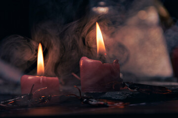 Witchcraft composition with burning candles, books, jewelry and pentagram symbol, occult concept,...