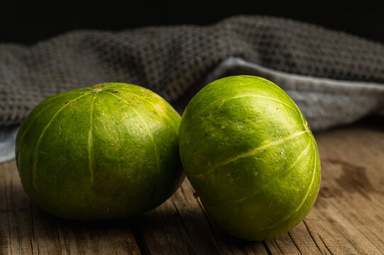 backlit fruits and vegetables zapallito on wood 