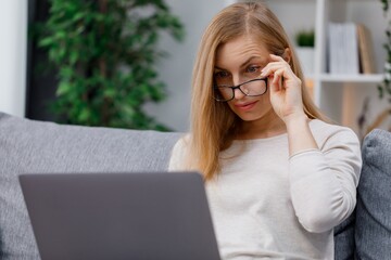 Surprised woman looking on laptop