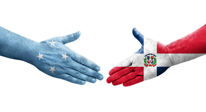 Handshake between Micronesia and Dominican Republic flags painted on hands, isolated transparent image.
