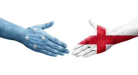 Handshake between Micronesia and England flags painted on hands, isolated transparent image.