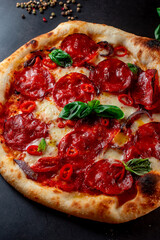 pizza with salami and tomatoes