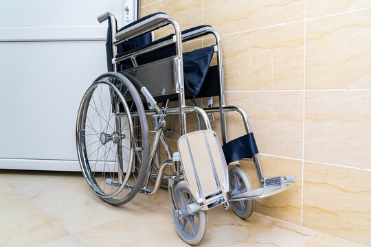 Folding wheelchair for people with special needs or disabilities with selective focus and blurry background