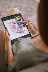 Artist or designer making new project, drawing on a graphic tablet with pencil, close-up on a...