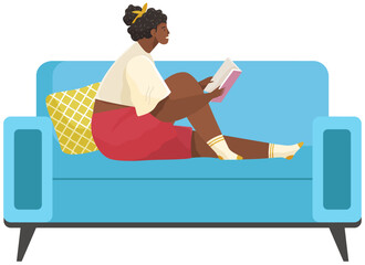 Young woman reading book, sitting on pillows in modern chair. Leisure and education. Relaxation with literature. Girl relaxing at home. Student reads textbook. Read a book