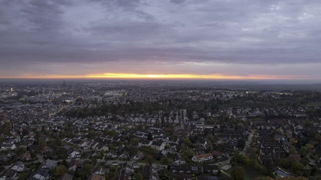 Western part of city of Ulm while colorful dawn in autumn aerial time lapse