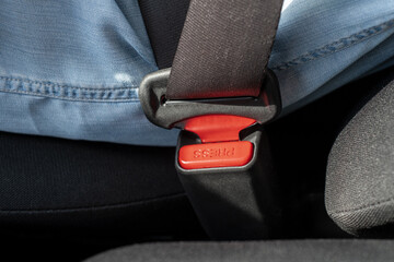 Close-up of red button Fastening Seat Belt to unlock seat belt in car