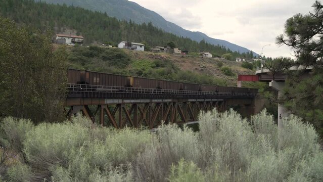 Rail Bridge and Train in Lytton BC 4K UHD. Train cars crossing a rail bridge in Lytton BC, Canada. 4K UHD.
