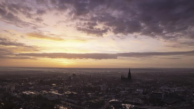 Ulm city center and minster while colorful sunrise and dawn aerial time lapse
