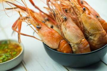 Close up boiled river shrimp in black bowl, Thai style seafood homemade.