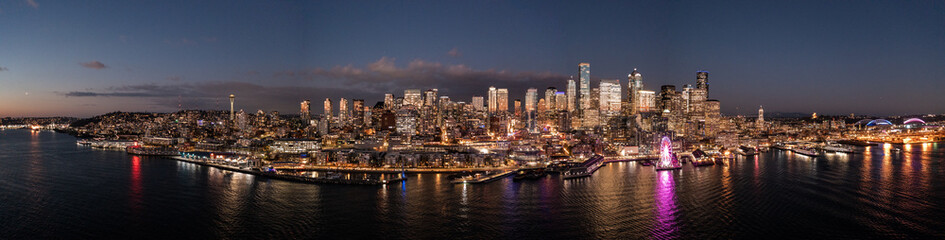 Fototapeta na wymiar Seattle, Washington, USA - November 2022, night aerial view of illuminated Seattle Downtown and the Waterfront pier area with The Seattle Great Wheel - aerial panoramic view 