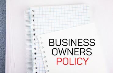 Business owners policy - text concept on notepad sheet. Business concept.