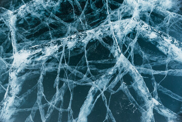 The beautiful Baikal ice with magical cracks before your eyes. This is really cool. The camera moves down the ice. Extreme close-up view.