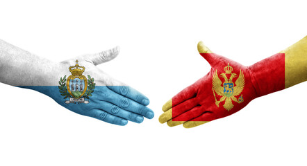 Handshake between Montenegro and San Marino flags painted on hands, isolated transparent image.