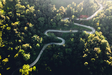 traveling on winding mountain road,Aerial View Of Winding Road Amidst Trees