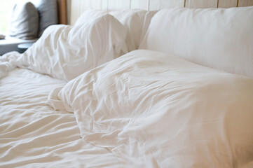 Fototapeta na wymiar white pillows on crumpled bed