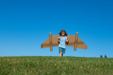 Happy child playing with toy jetpack. Kid pilot having fun outdoor. Success child, innovation and leader. Creative and start up concept. Imagination child having startup idea.