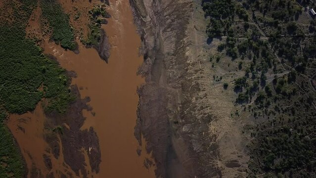 Beautiful 4k aerial view from above of the forest and Lake Natron, Tanzania, creating a beautiful texture of brownish and green colors.