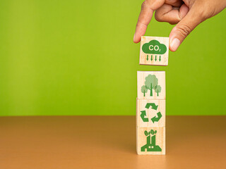 Net-zero emissions. Wooden cubes with co2, tree, recycle, and industry icons