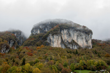 cornalba crag among the colorful trees in autumn