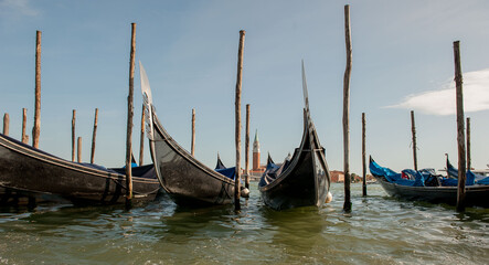 Fototapeta na wymiar Gondola at jetty with background Giudecca in Venice