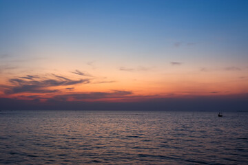 Calm sea with sunset sky and sun through clouds above. sky ocean meditation calm sea horizon over water