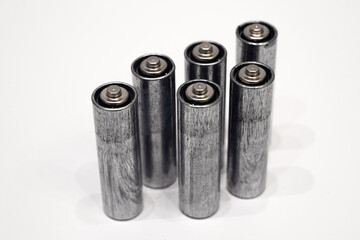 Metal batteries on white isolate.Disposal of old batteries.Old batteries stand on a white background.