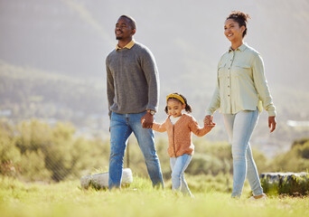 Happy family, walking and relax at a park with girl and parents, holding hands and enjoy their...