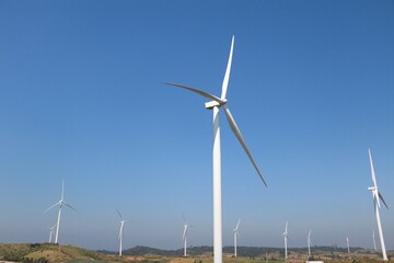 Landscape with hills and wind turbines and blue sky backgound.	 - 544783916