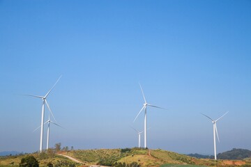 Landscape with hills and wind turbines and blue sky backgound.	 - 544783938