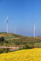 Landscape with hills and wind turbines and blue sky backgound.	 - 544783976