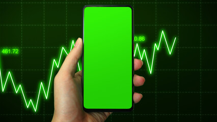 Hand businessman holding phone mobile on green screen on Stock markets uptrend dynamic chart on dynamic green background. Concept of financial stagnation, recession, crisis, business crash