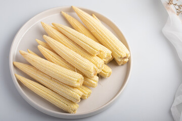 baby corn in a white plate
