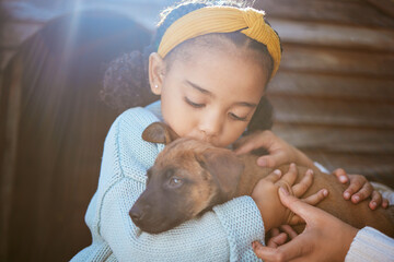 Dog, kiss and child outdoor with a love hug, care and animal friend care for new family puppy. Pet,...