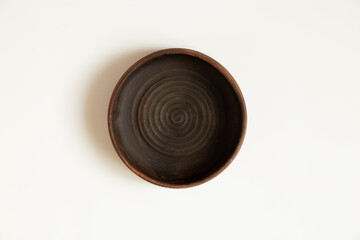 Earthenware deepware stands on a white background close up
