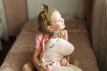 beautiful girl with unicorn in her children's room