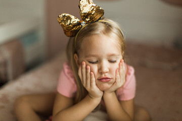 beautiful little girl is bored in her children's room