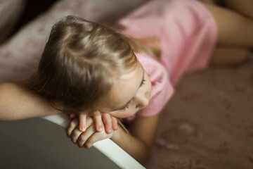 Obraz na płótnie Canvas little girl sleeping on her bed in the children's room