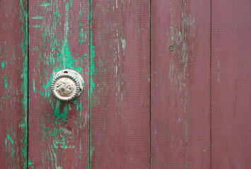 Old wooden door with a metal handle.